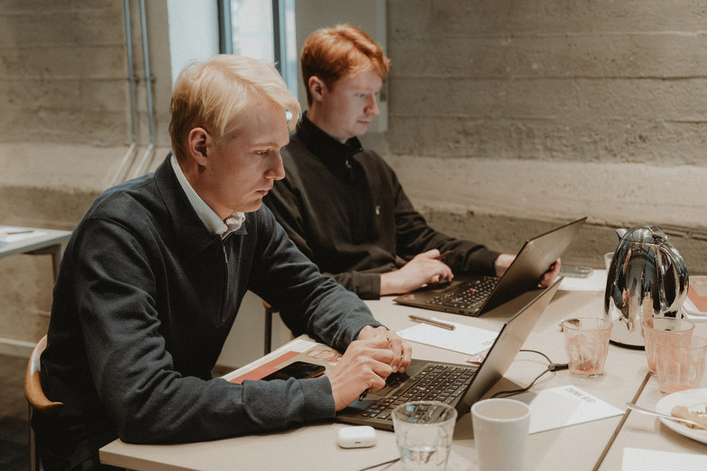 Two oung men working at their computers