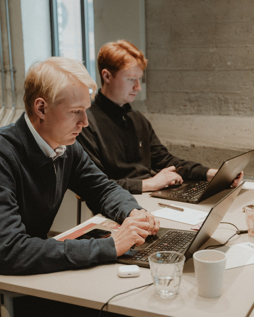 Two oung men working at their computers
